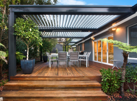 Modern deck with louvered pergola in Lakeview